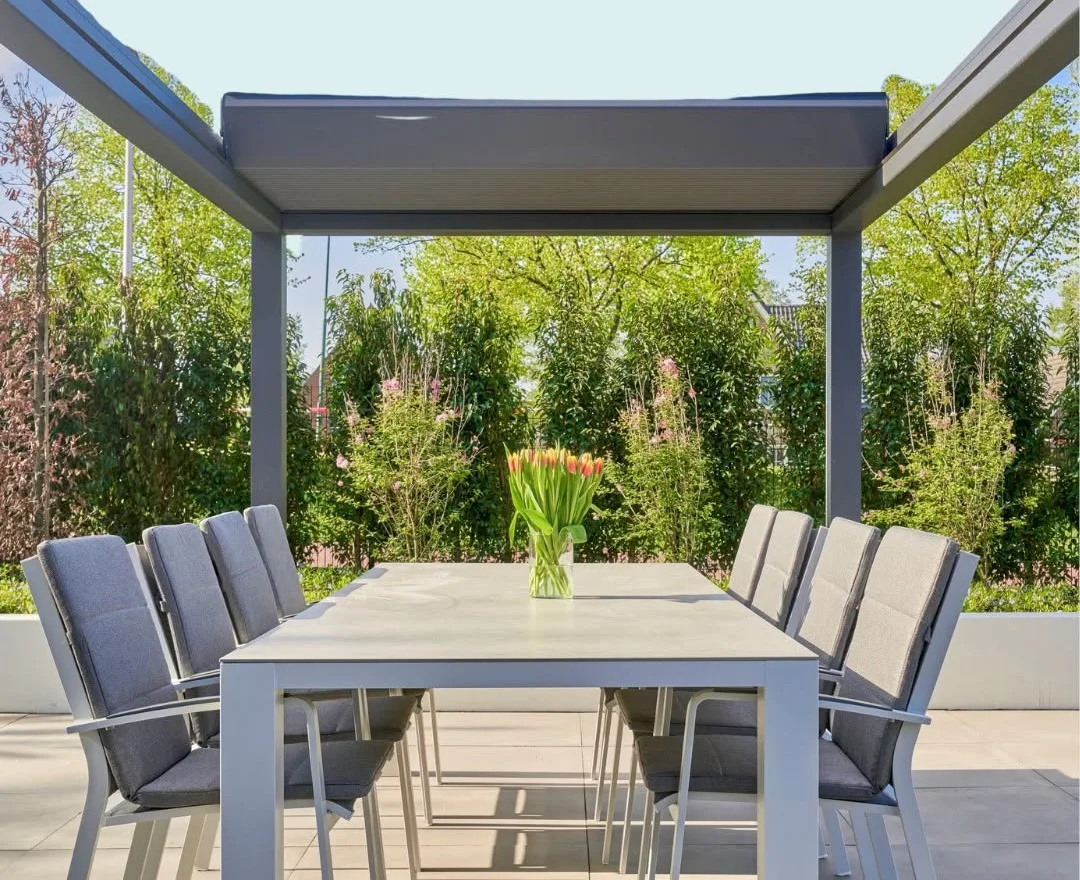 Louvered roof veranda with an outdoor dining table set for entertaining