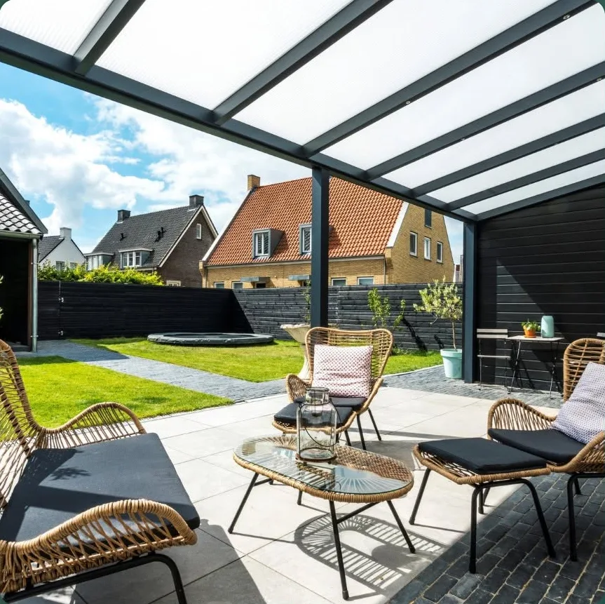 Glass-roofed veranda with lounge seating, sheltered from the rain